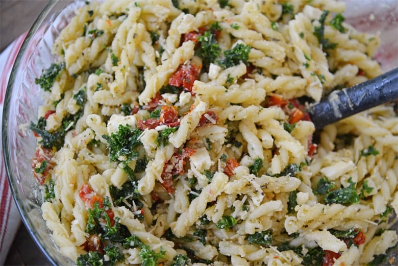 kale pasta salad in a mixing bowl 