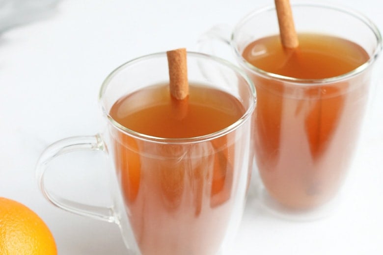 side view of mulled cider in glass mugs 