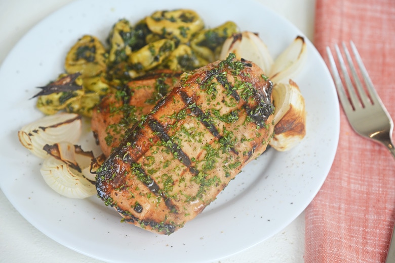 grilled pork on a plate with grilled onions