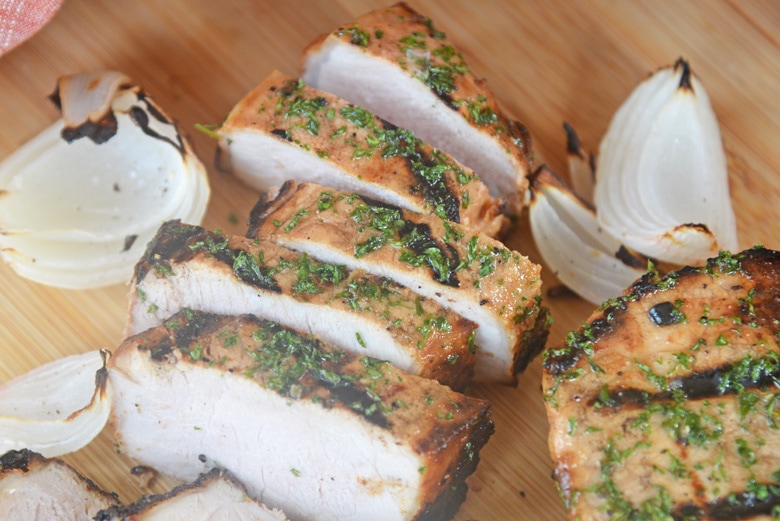 sliced pork chop on a cutting board 