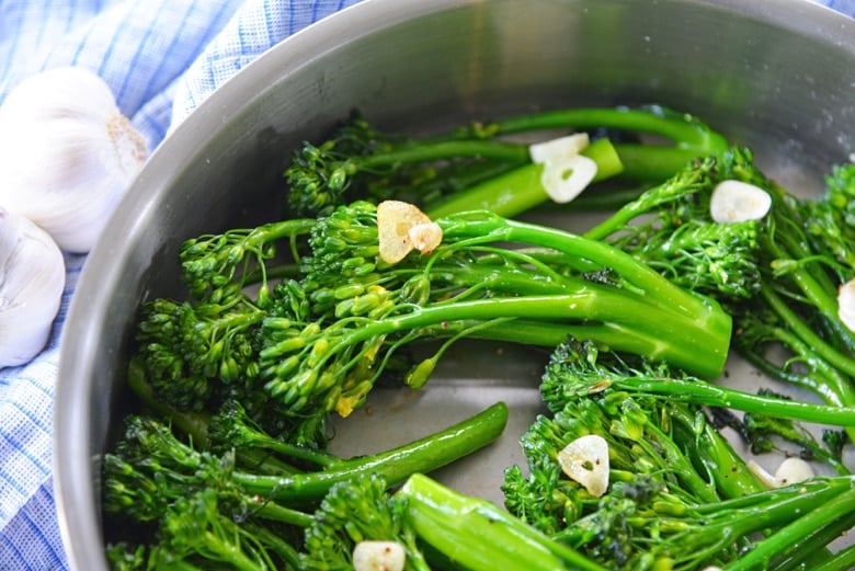 close up of broccolini in a skillet 