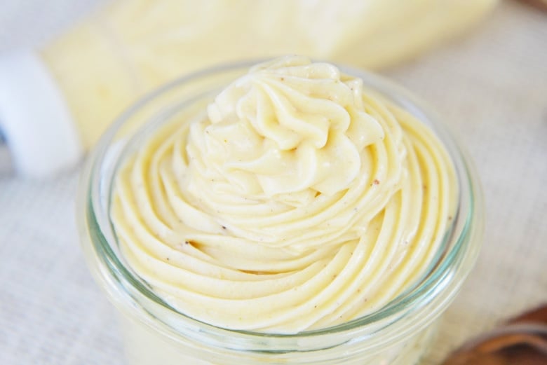 angle of cream cheese frosting in a glass bowl 
