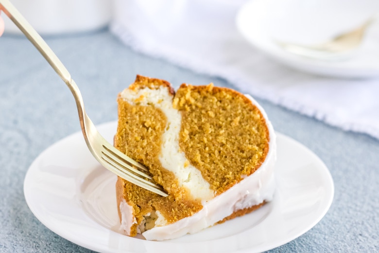 fork digging into a slice of pumpkin cream cheese pound cake 