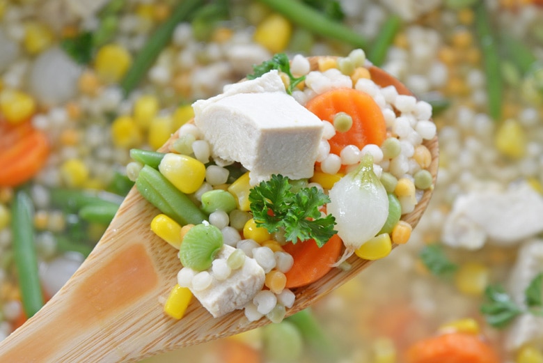 wooden spoon holding turkey soup 