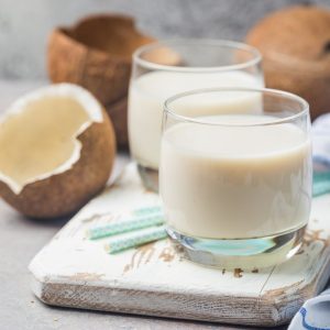 glass of coconut milk with blue straws
