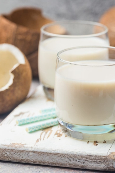 glass of coconut milk with blue straws