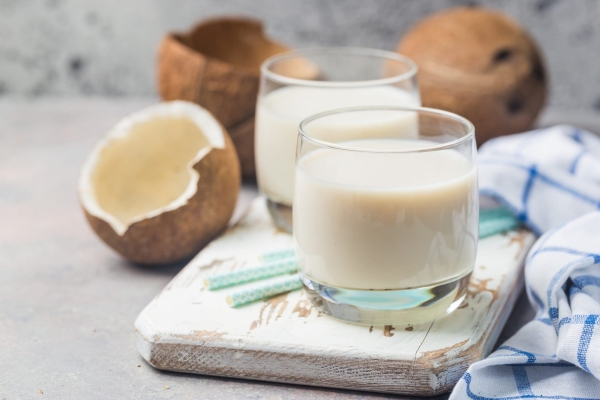 glass of coconut milk with blue straws