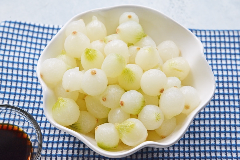 frozen pearl onions in a bowl with blue linen 