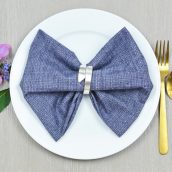 bow tie napkin fold on a blue napkin