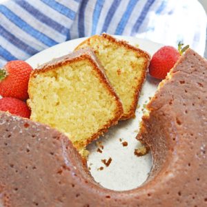 sliced butter cake on a platter with blue linens