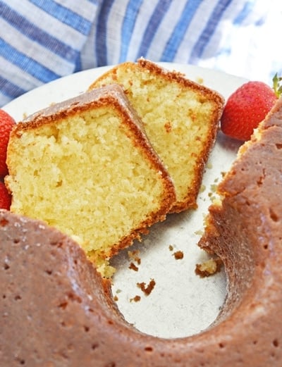 sliced butter cake on a platter with blue linens