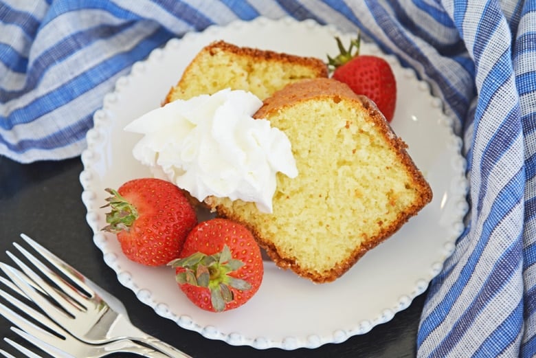 two slices of butter cake, strawberries and whipped cream 