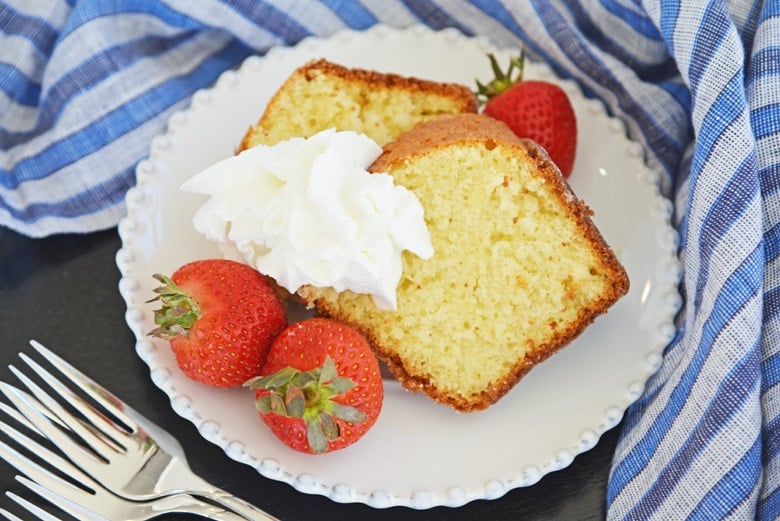 two slices of butter cake, strawberries and whipped cream 