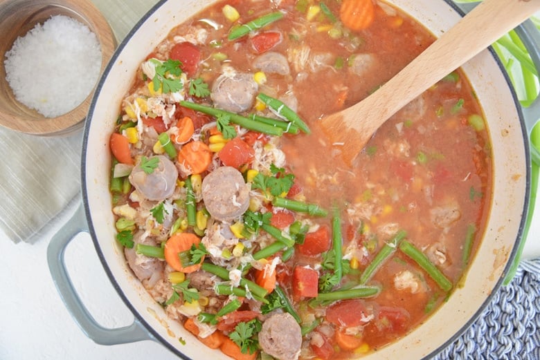 spicy crab and sausage soup in a large cast iron pot  