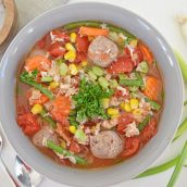 overhead of vegetable, crab and sausage soup