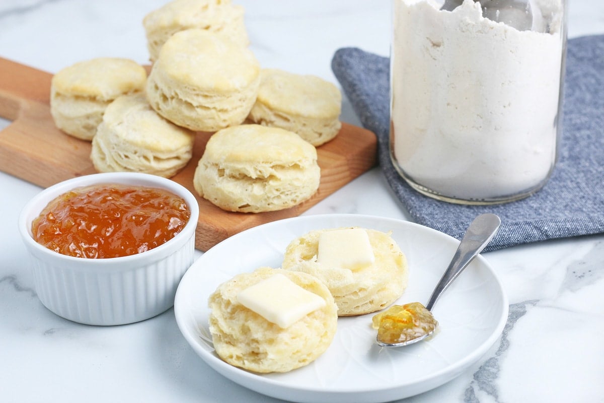 sliced biscuit on a white plate with jam 