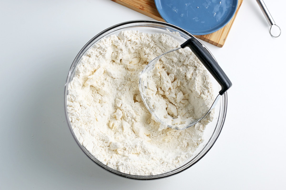 cutting shortening into bisquick mix in a mixing bowl 