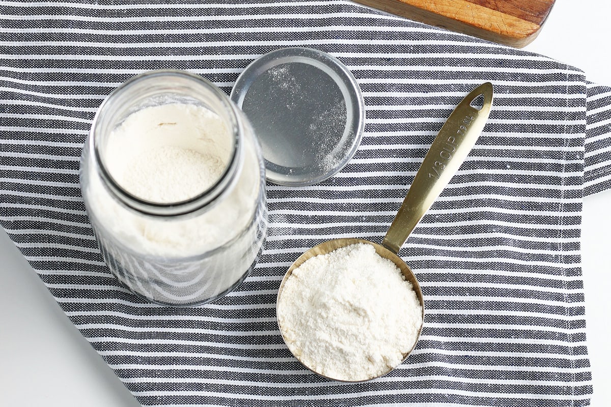 overhead of cake mix in a mason jar and measuring cup 