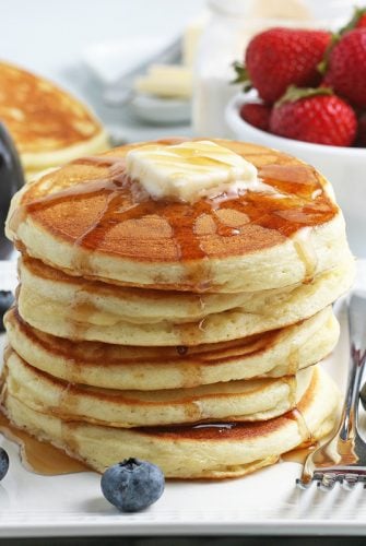 stack of DIY pancakes with fruit and syrup