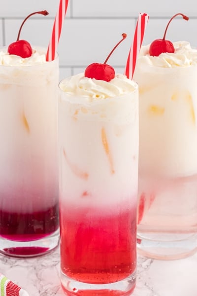 head on homemade cream soda with cherry garnish