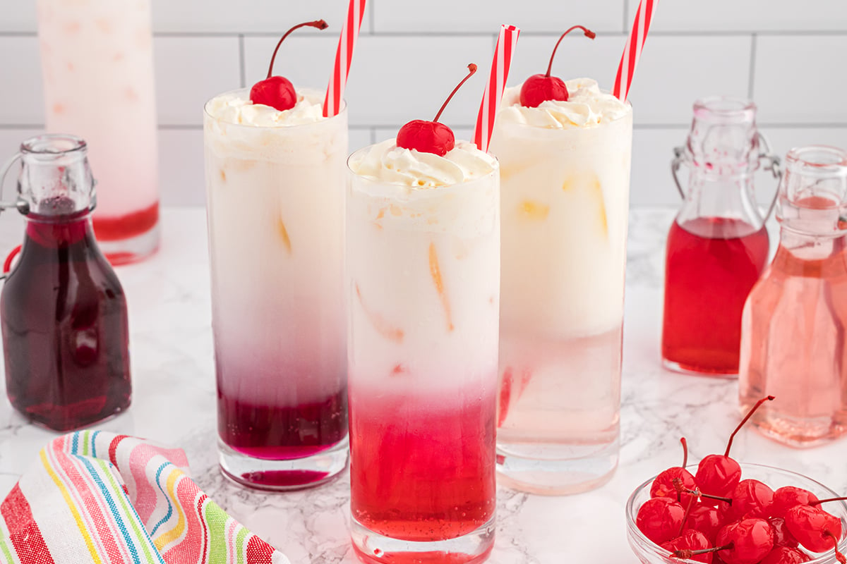 head on homemade cream soda with cherry garnish