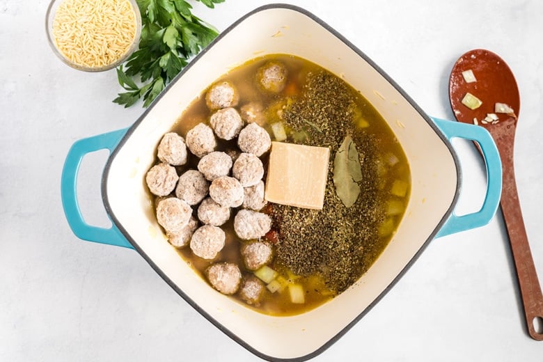 herbs, frozen meatballs and parmesan rind