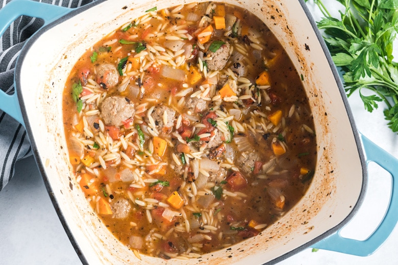 italian meatball soup in a cast iron pot 