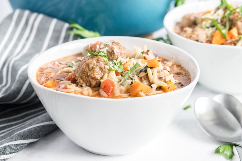 side view of meatballs in a soup bowl 