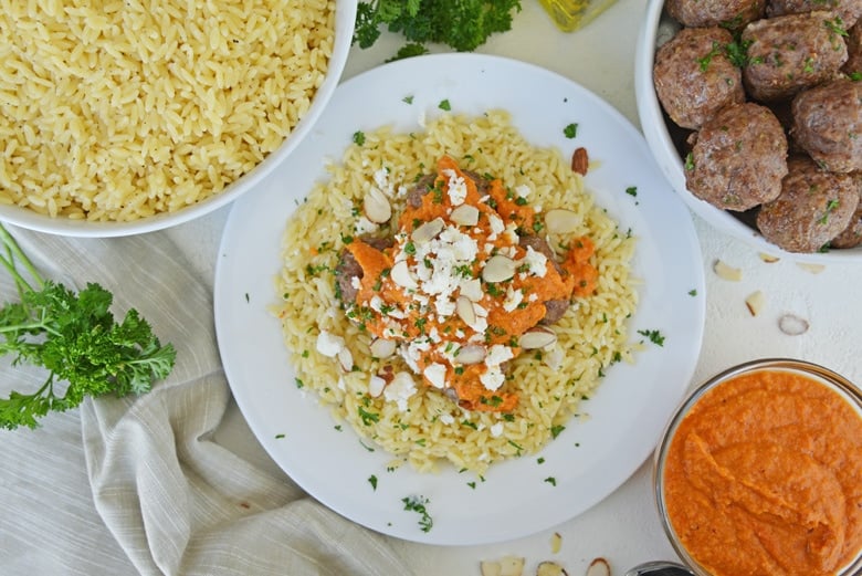 overhead of lamb meatballs with orzo and sauce 