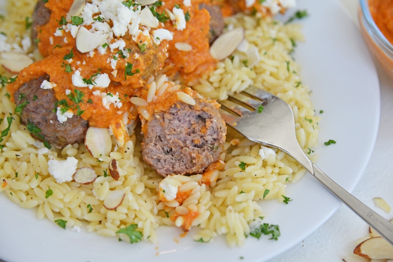 lamb meatball cut in half with a fork 