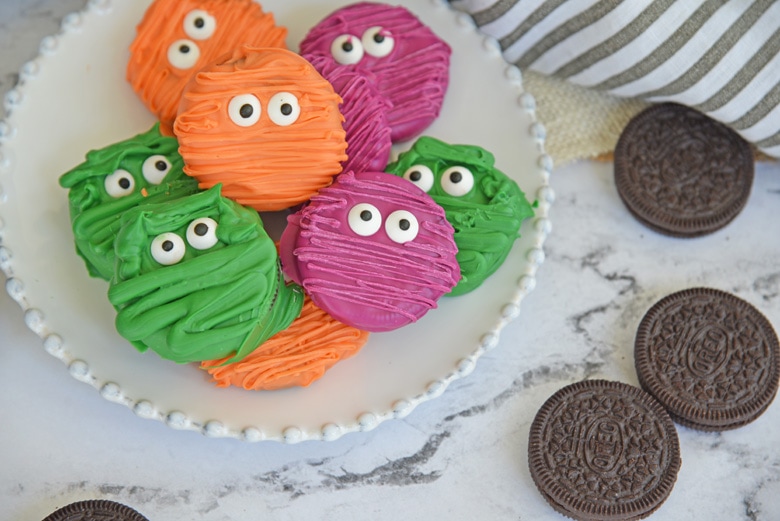 plate of chocolate covered oreos decorated as a mummy 