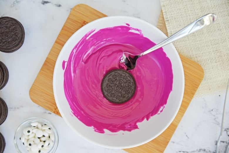 cookie dipping in purple chocolate 