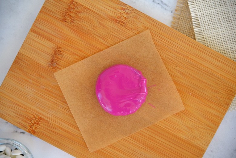 purple chocolate covered oreo on a piece of parchment paper 