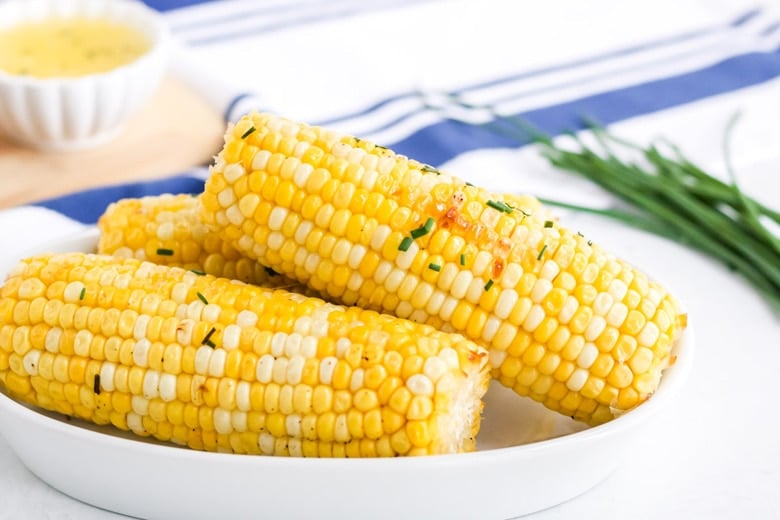 roast corn on the cob in a serving dish 