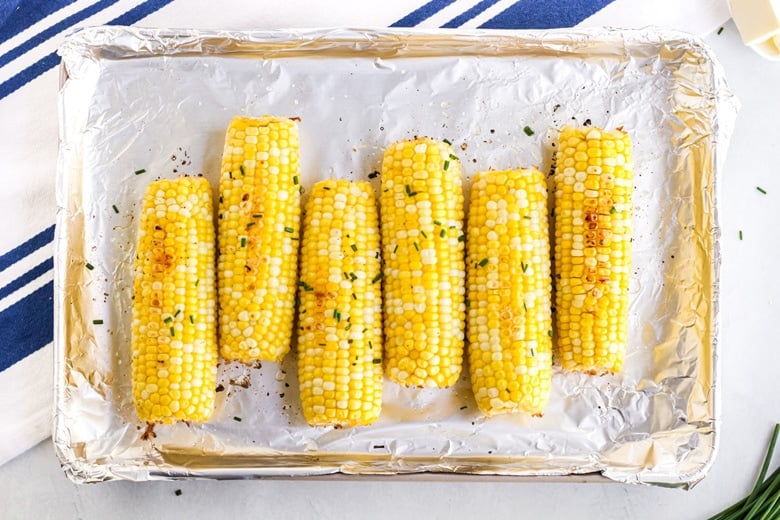 ears of corn on a rimmed baking sheet 