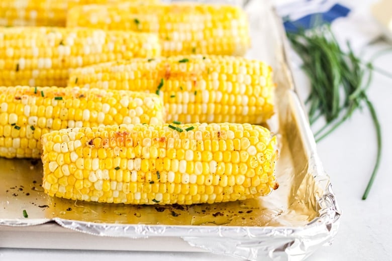 close up of oven roasted corn with chive butter