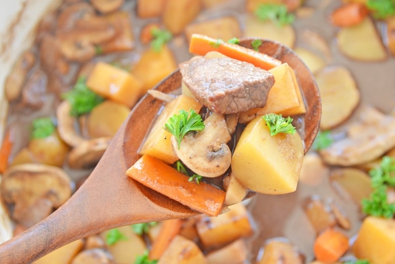 wooden spoon with beef, potatoes and parsnips