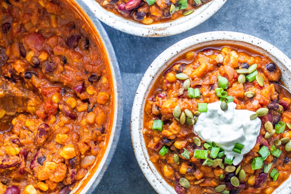 overhead of pot of chili and vegetarian chili in a bowl 