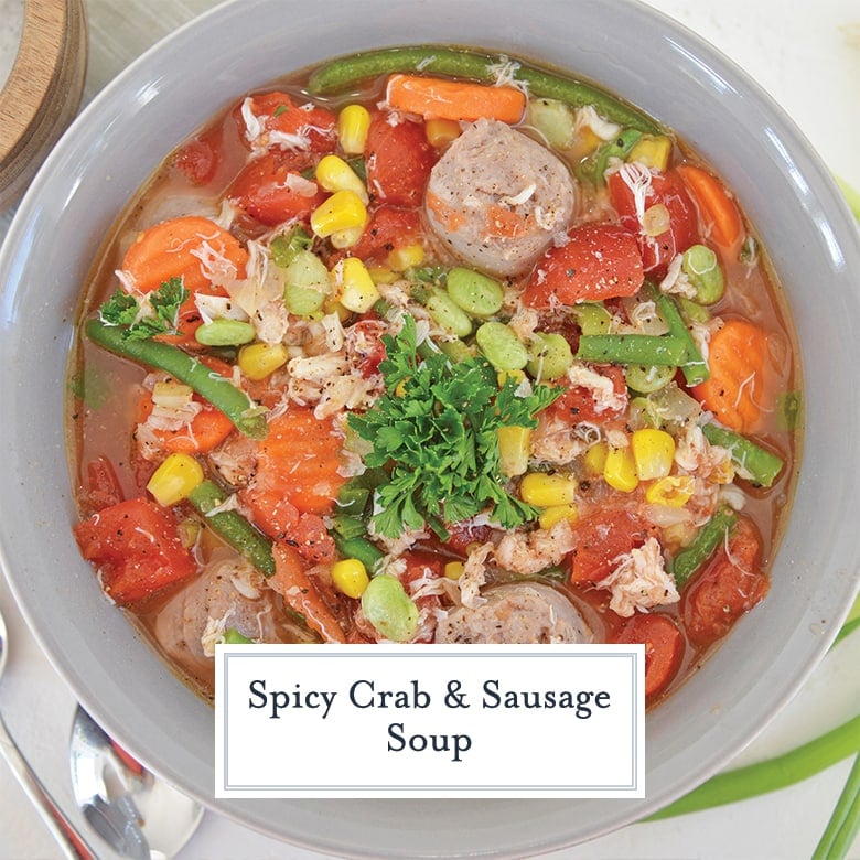 overhead of crab and sausage soup with vegetables in a gray bowl 