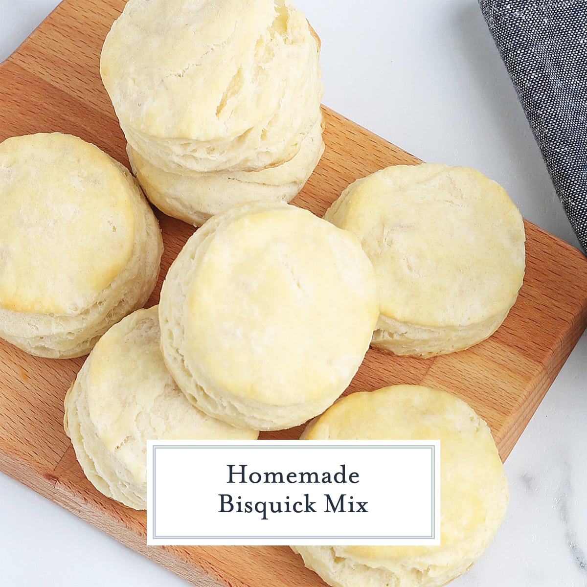 pile of homemade biscuits on a wood cutting board 