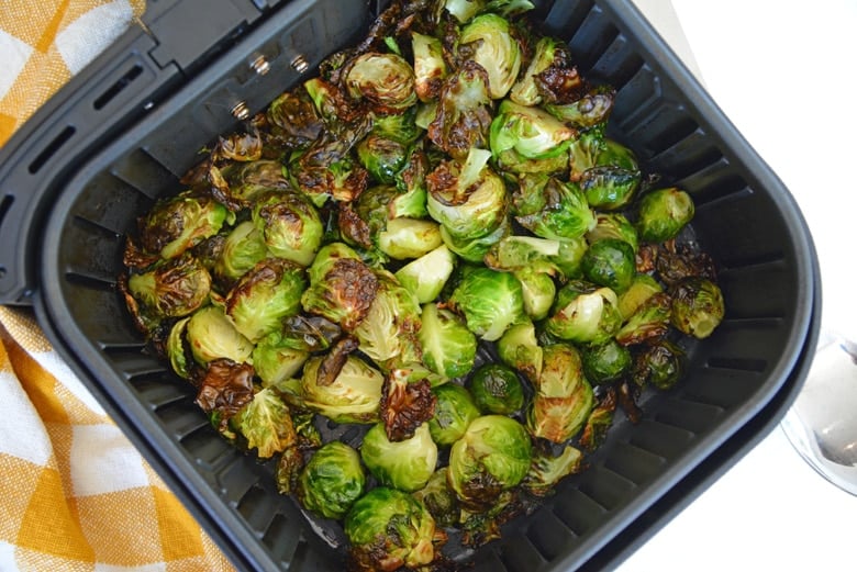 crispy brussels sprouts in an air fryer basket  
