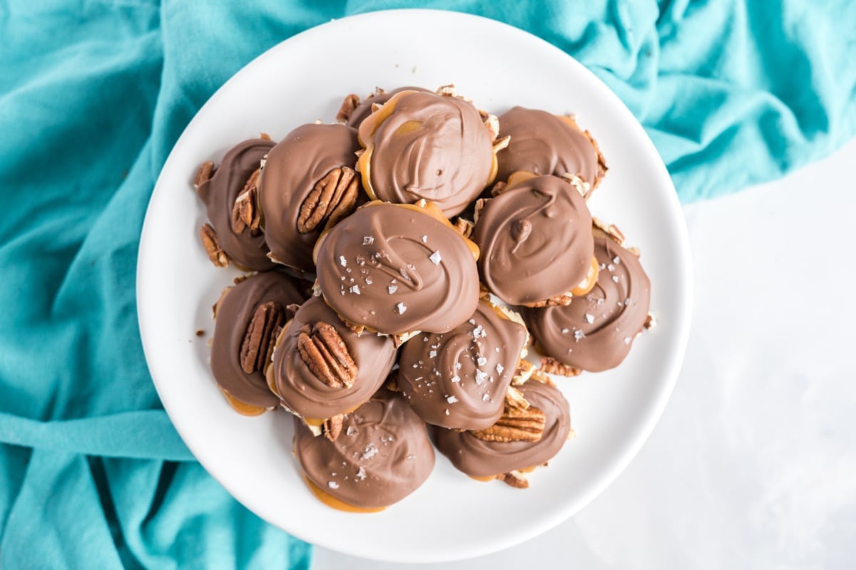 overhead plate of pecan turtles with sea salt and whole pecans 