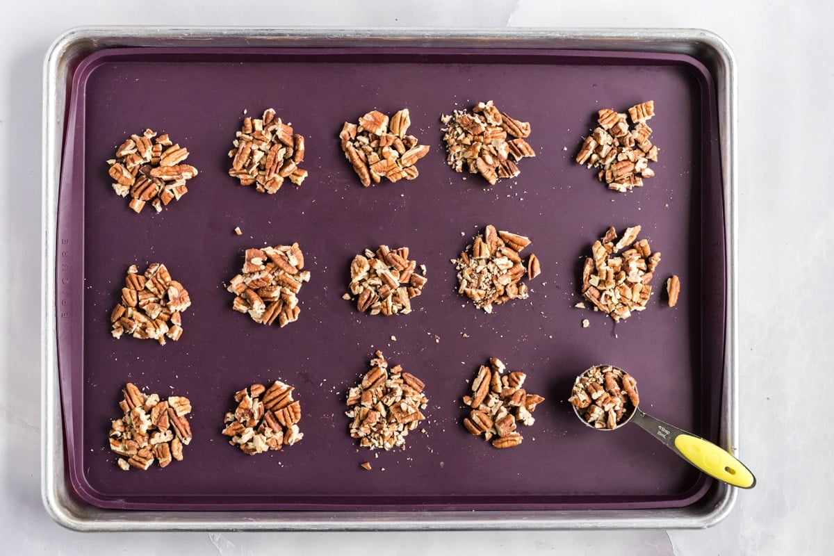 pecan piles on a baking sheet 