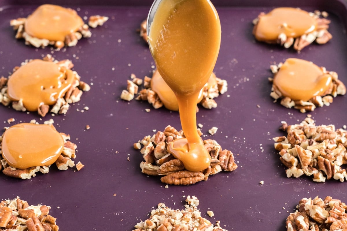 pouring caramel on pecan clusters 