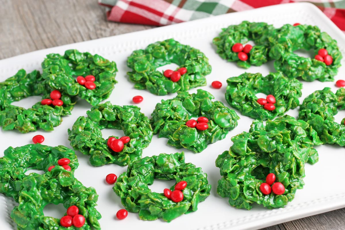 angle view of cornflake wreath cookies on a white serving platter 