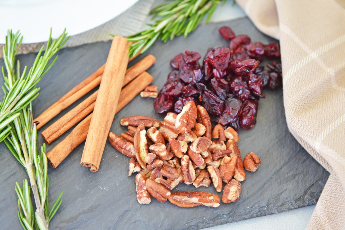 ingredients for cranberry goat cheese roll on a slate plate 