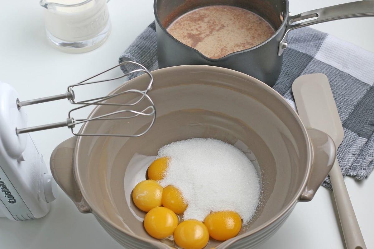 raw egg yolks and sugar in a mixing bowl 