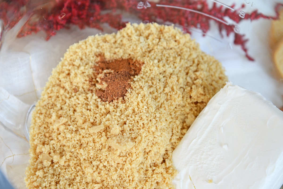 cookie crumbs, spices and cream cheese in a bowl  