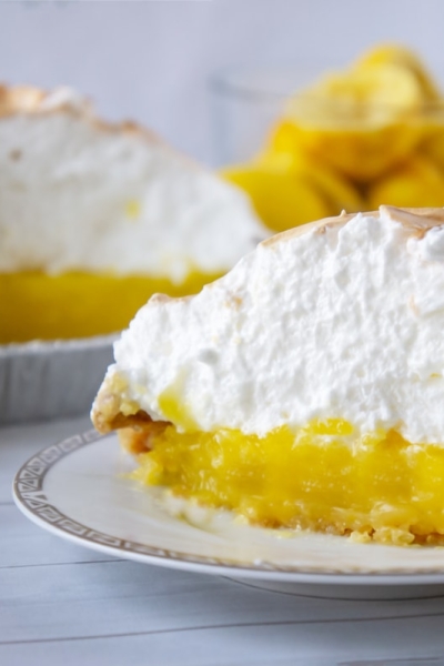 Slice of lemon meringue pie on a white plate