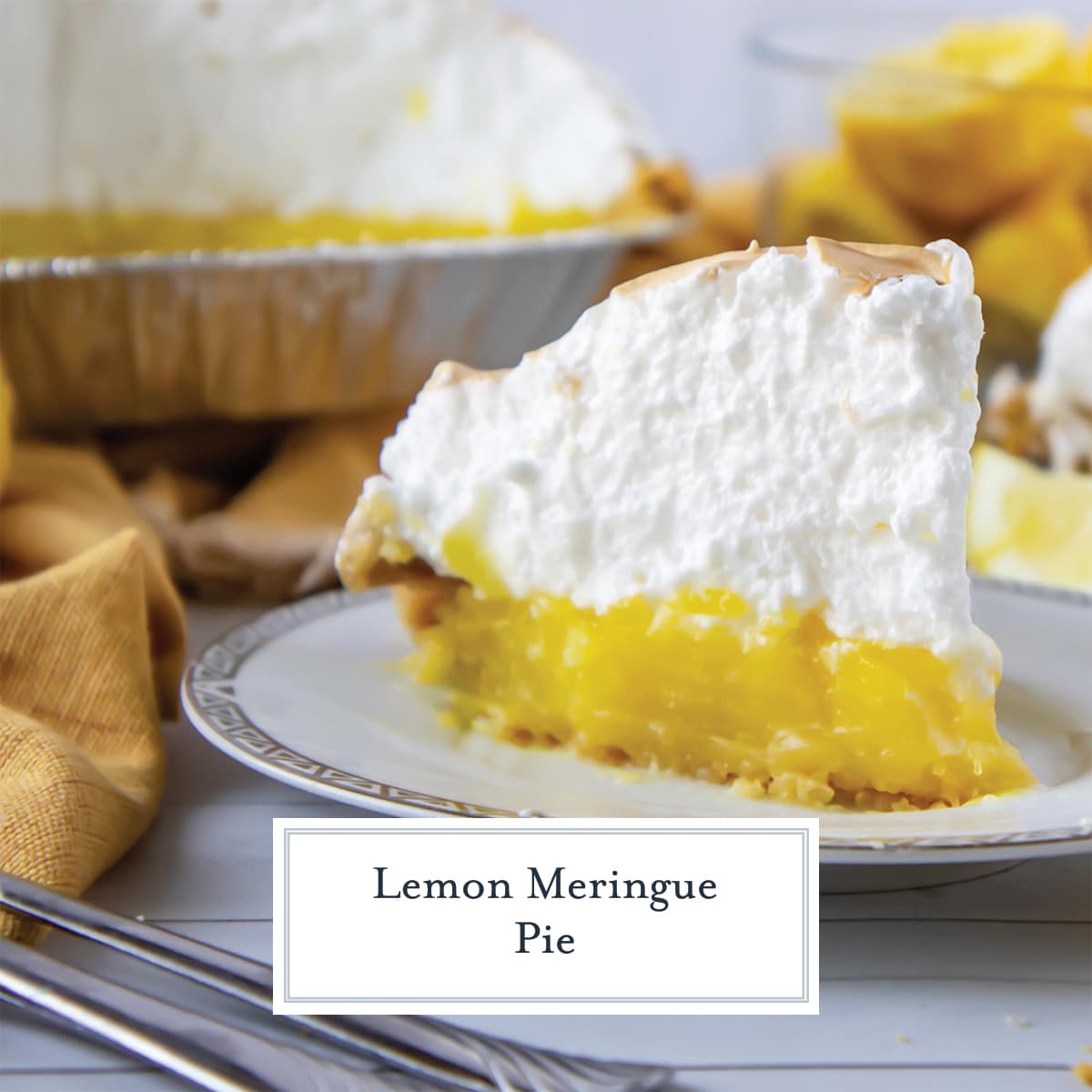 tall slice of lemon meringue pie on a gold and white plate